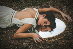 Model Girl Lying On Grass Embracing Mirror Wallpaper