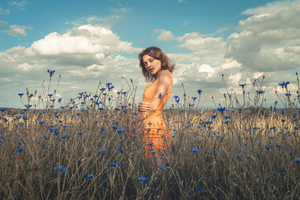 Orange Dress Model In Field Outdoor 4k Wallpaper