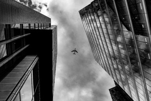 Plane Between Two Buildings Monochrome