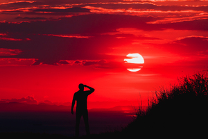 Silhouette Of Man During Red Sun Wallpaper