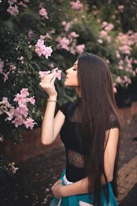 Attractive Beautiful Girl Smelling Flowers