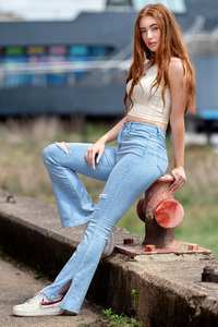 Beautiful Girl Poses In Jeans Locking Eyes With The Viewer (540x960) Resolution Wallpaper