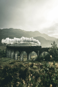 1080x1920 Black Train On Railway Bridge Under Heavy Clouds