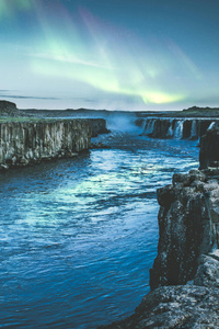 Body Of Water Between Rock Formation (320x480) Resolution Wallpaper