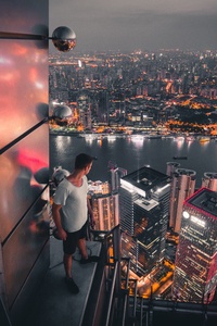 Boy Standing On The Rooftop Of Building Looking Down 5k (240x320) Resolution Wallpaper