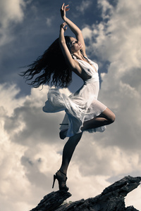 Brunette Girl Dancing On Mountain Top Clouds (640x1136) Resolution Wallpaper