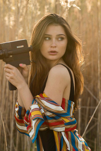 Brunette Girl In Field With Camera (800x1280) Resolution Wallpaper