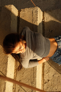 Brunette Girl Lying Down Gracefully In Shorts (320x568) Resolution Wallpaper