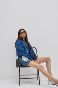 Denim Jacket Girl Sitting On Chair (2160x3840) Resolution Wallpaper