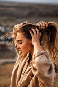 Girl Embracing The Breeze With Closed Eyes And Holding Her Hairs (640x1136) Resolution Wallpaper