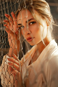 Girl Fence Looking At Viewer 4k (320x480) Resolution Wallpaper