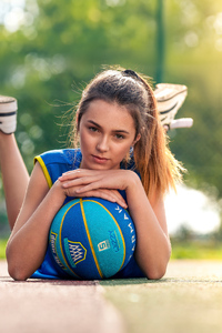 Girl Lying Down With Basketball In Ground (2160x3840) Resolution Wallpaper