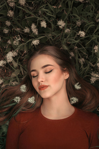 Girl Lying On Grass Bed Closed Eyes 4k (2160x3840) Resolution Wallpaper