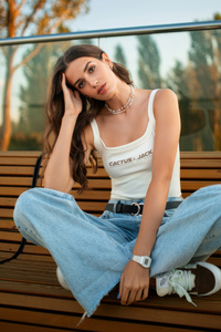 Girl Sitting Bench Wearing Jeans (1280x2120) Resolution Wallpaper