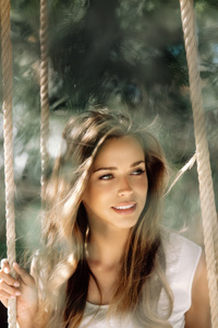 Girl Smiling Cute On Swings (1440x2560) Resolution Wallpaper