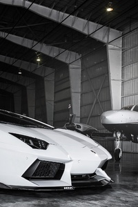 Lamborghini Aventador Roadster In The Plane Hangar (2160x3840) Resolution Wallpaper
