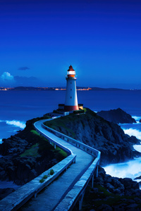 Lighthouse On Rocky Shores (320x568) Resolution Wallpaper