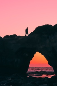 Man Walking Over Rock Silhouette