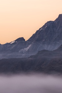 Mountain Range Covered In Fog (640x1136) Resolution Wallpaper
