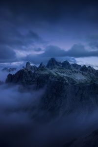 Mountains Cliff Covered Under Fog Mist 5k (1125x2436) Resolution Wallpaper