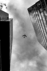 Plane Between Two Buildings Monochrome
