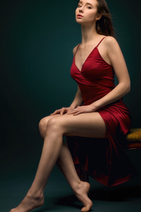 Red Dress Beautiful Girl Sitting On Table (2160x3840) Resolution Wallpaper