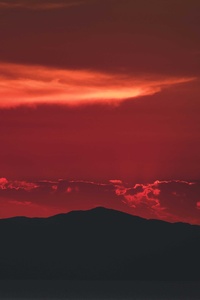 Sun Is Setting Over A Mountain Range 5k (640x960) Resolution Wallpaper