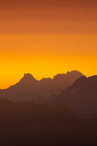 Sun Setting Over A Mountain Range (750x1334) Resolution Wallpaper