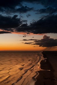 Sun Setting Over Ocean On Beach (1080x2400) Resolution Wallpaper