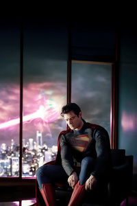 Superman Adjusting His Shoes (320x568) Resolution Wallpaper