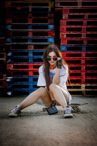 Urban Girl Sitting On Skateboard With Toshiba Music Player (1440x2960) Resolution Wallpaper