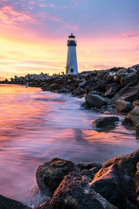 Waves And A Lonely Lighthouse (320x568) Resolution Wallpaper