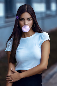 Young Girl Making A Bubble With A Chewing Gum 4k (240x320) Resolution Wallpaper